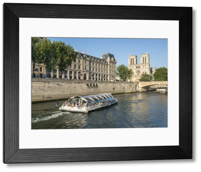 Framed Print : Boat tour along the banks of the Seine with cathedral Notre Dame in the background Framed Print : Boat tour along the banks of the Seine with cathedral Notre Dame in the background