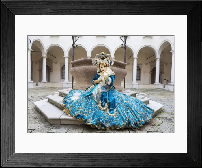 Framed Print : A woman sits in a magnificent costume in front of a well during the Venice Carnival Framed Print : A woman sits in a magnificent costume in front of a well during the Venice Carnival