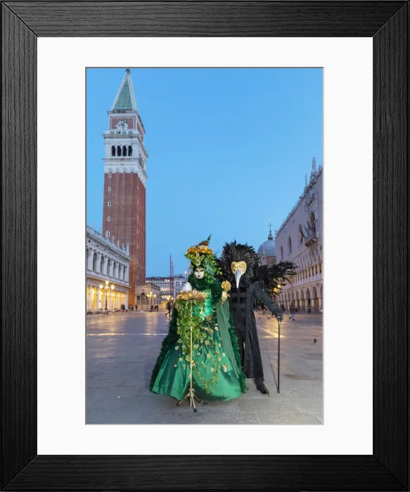 Framed Print : A couple wearing masks and Venetian costume stand in St Marks square during Framed Print : A couple wearing masks and Venetian costume stand in St Marks square during