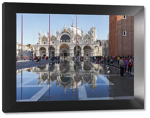 The St Marks Basilica reflected in high tide water (Acqua alta), Venice, Veneto