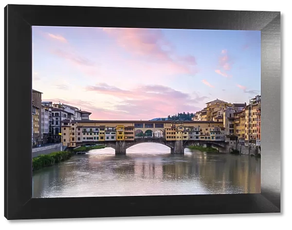 Ponte Vecchio on the Arno river and buildings in the old town at sunrise, Florence