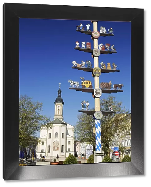 Maipole and church, Traunstein, Chiemgau, Bavaria, Germany