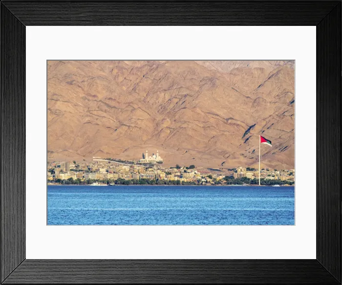 Framed Print : Jordan, Aqaba Governorate, Aqaba. Jordanian flag and buildings in front of mountains Framed Print : Jordan, Aqaba Governorate, Aqaba. Jordanian flag and buildings in front of mountains