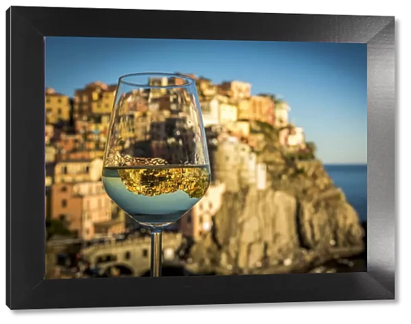 europe, Italy, cinque Terre. view of the village of Manarola with a reflection in