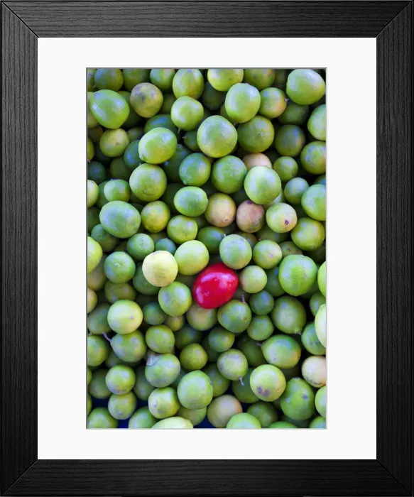 Framed Print : Mexico. A red fruit in a pile of limes Framed Print : Mexico. A red fruit in a pile of limes