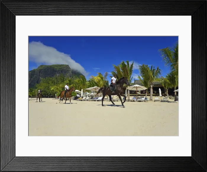 Framed Print : Horse riders on the beach in front of a luxury hotel on the Le Morne Peninsula
