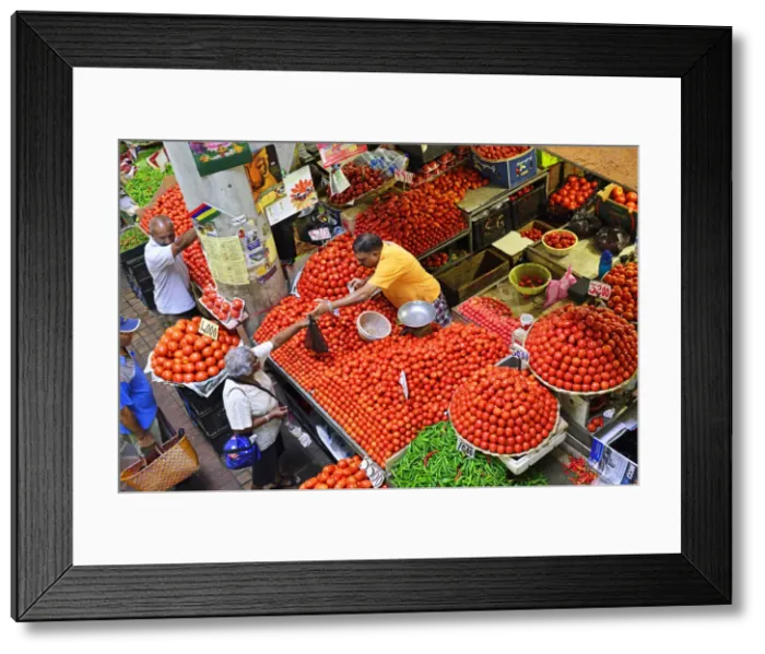 Framed Print : A tradesmen selling tomatos from his stall at the Big Vegetable Market, Port Louis Framed Print : A tradesmen selling tomatos from his stall at the Big Vegetable Market, Port Louis