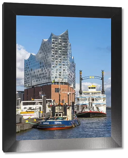 Germany, Hamburg, HafenCity. Boats docked near the Elbphilharmonie (Elbe Philharmonic