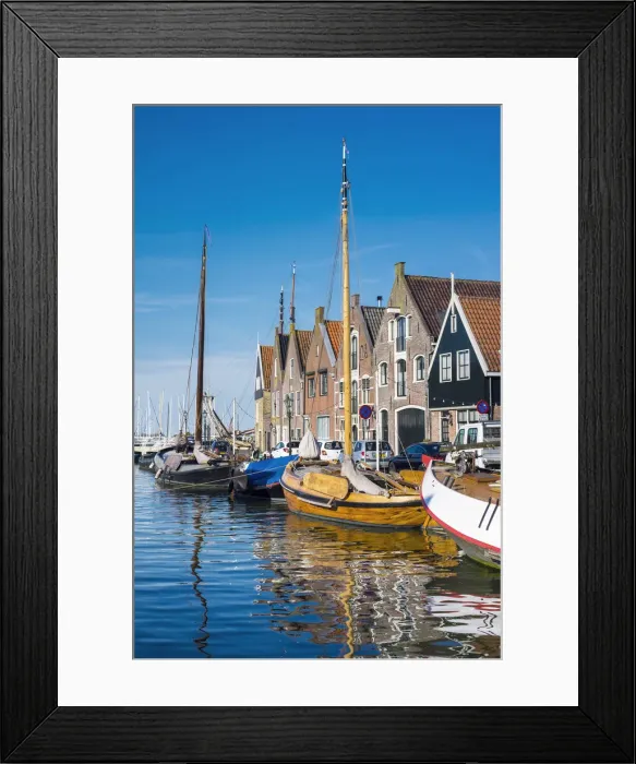 Framed Print : Netherlands, North Holland, Monnickendam. Buildings and boats along the harbor quay