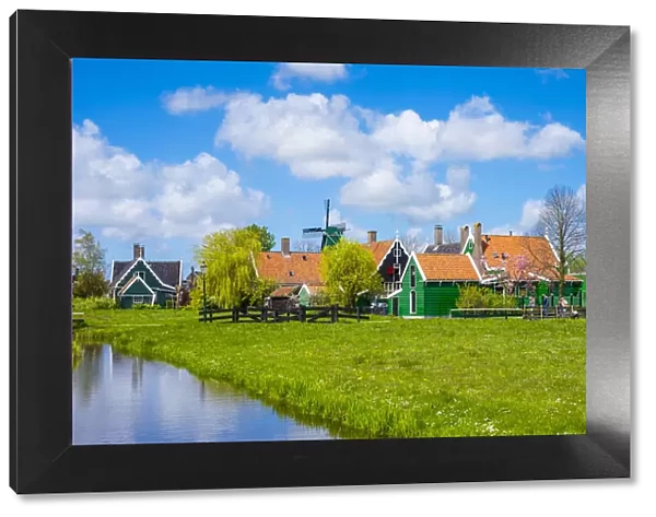 Netherlands, North Holland, Zaandam. Historic windmills and houses in the village