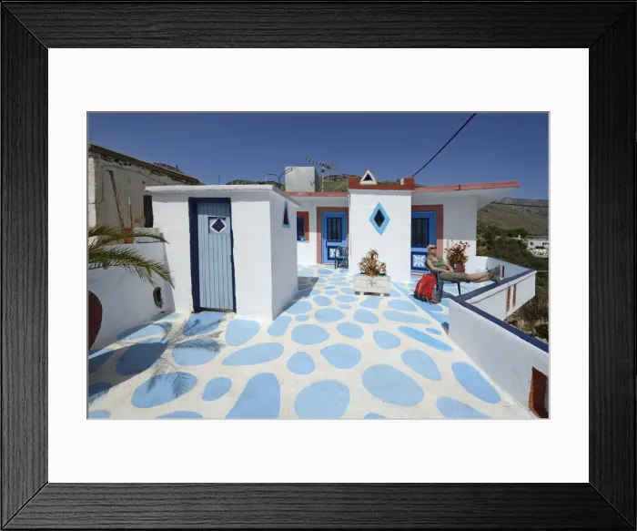 Framed Print : Tourist with backpack resting on the Dachterrassei a Hotelsl in Komitades, Imbros Gorge