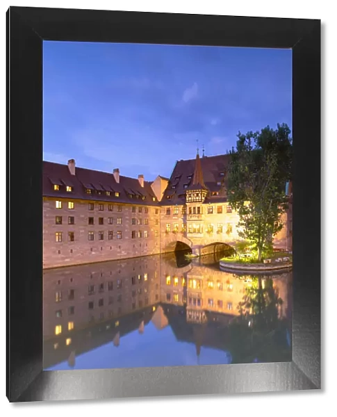 Heilig-Geist Spital on River Pegnitz at dusk, Nuremberg, Bavaria, Germany