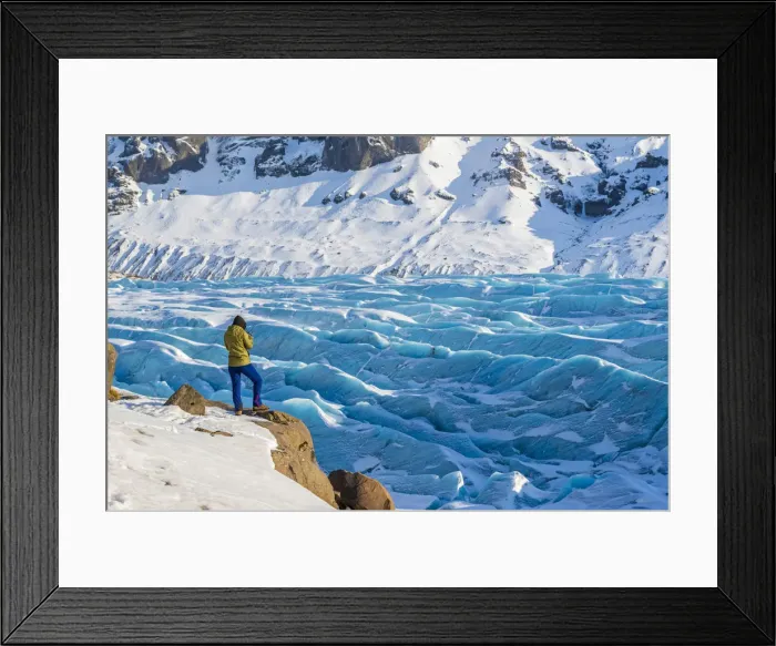 Framed Print : Southern Iceland, Europe. Woman in front of blue glacier in wintertime Framed Print : Southern Iceland, Europe. Woman in front of blue glacier in wintertime