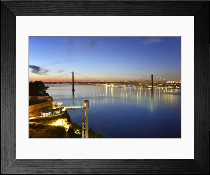 Framed Print : Lisbon and 25 de Abril bridge over the Tagus river, at dusk, seen from Almada. Portugal
