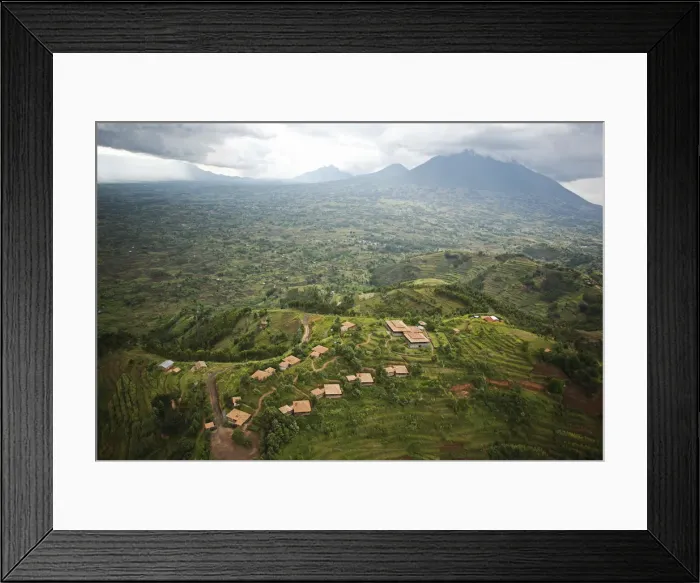 Framed Print : Rwanda. The luxurious Virunga Safari Lodge sits below looming volcanoes Framed Print : Rwanda. The luxurious Virunga Safari Lodge sits below looming volcanoes