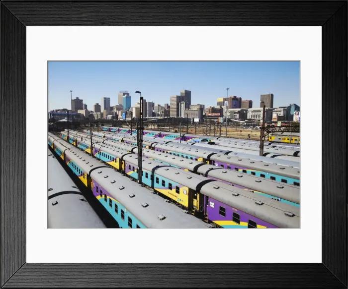 Framed Print : Train carriages at Park Station with city skyline in background, Johannesburg, Gauteng Framed Print : Train carriages at Park Station with city skyline in background, Johannesburg, Gauteng