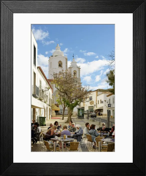 Framed Print : Tourists at a cafe and the church of Santo Antonio. Lagos Portugal Framed Print : Tourists at a cafe and the church of Santo Antonio. Lagos Portugal