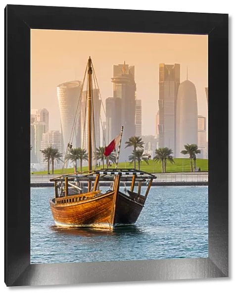 Dhow traditional sailing vessel with the financial area skyline behind, Doha, Qatar