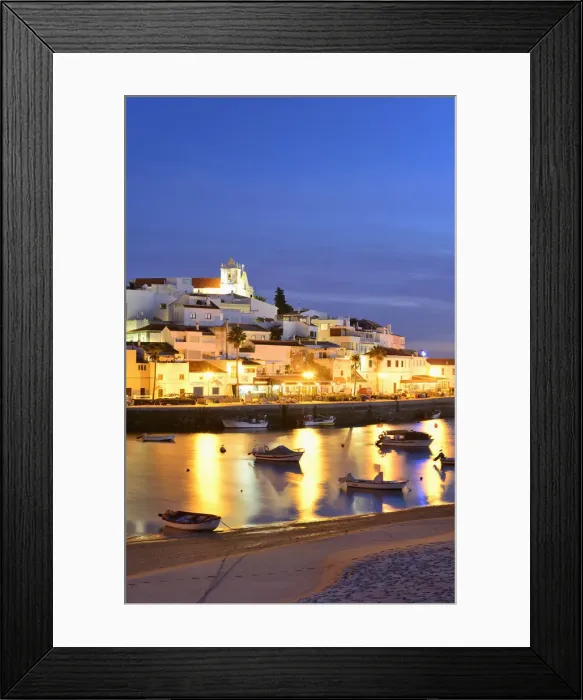 Framed Print : The traditional fishing village of Ferragudo at dusk, bordering the Arade river. Algarve Framed Print : The traditional fishing village of Ferragudo at dusk, bordering the Arade river. Algarve