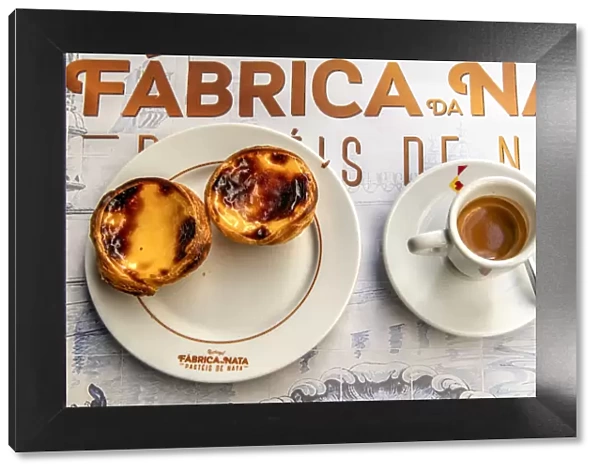 Pastel de belem or pasteis de nata custard tarts served with a cup of coffee in a