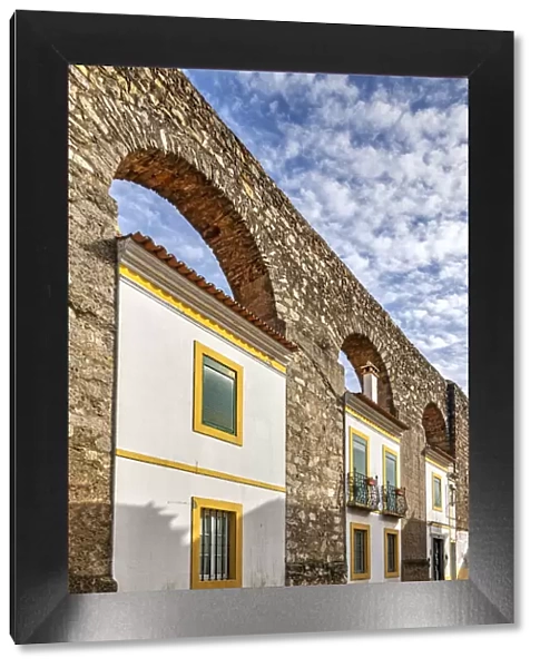 Houses built between the arches of the medieval Prata Aqueduct, Evora, Alentejo, Portugal