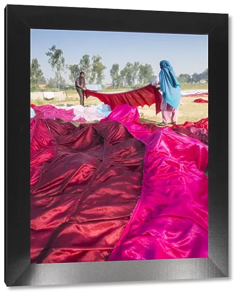 India, Uttar Pradesh, Agra, locals drying brilliant red and pink sarees in the sun