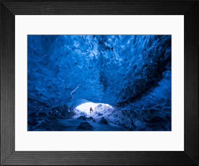 Framed Print : Man standing at entrance to an ice cave beneath a glacier, Iceland, Europe Framed Print : Man standing at entrance to an ice cave beneath a glacier, Iceland, Europe