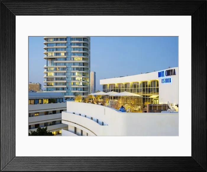 Framed Print : Israel, Tel Aviv-Yafo, Tel Aviv. Historic Hotel Cinema on Diezengoff Square at dusk