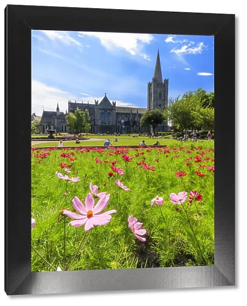 Europe, Dublin, Ireland, people sitting on the gardens at St. Patrick Cathedral