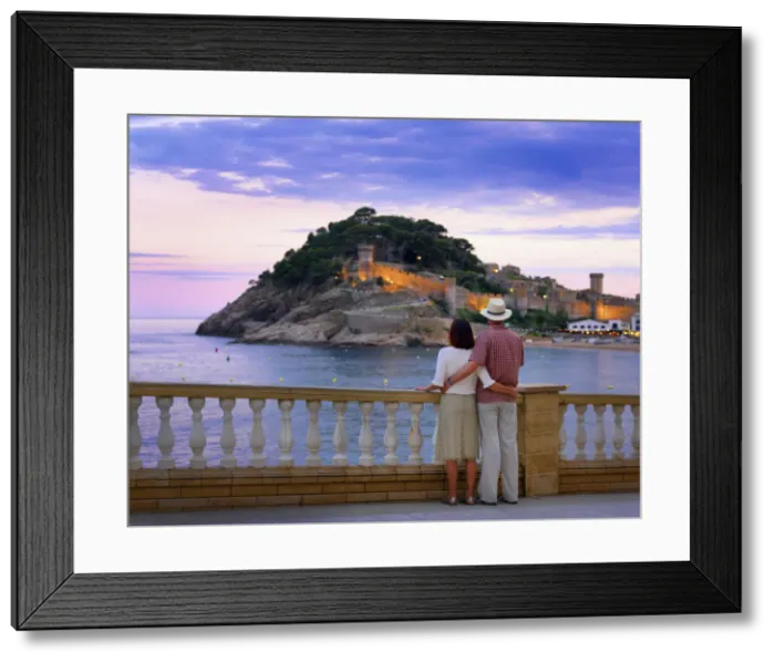 Framed Print : Spain, Catalonia, Costa Brava, Tossa de Mar, man and woman looking at view (MR) Framed Print : Spain, Catalonia, Costa Brava, Tossa de Mar, man and woman looking at view (MR)