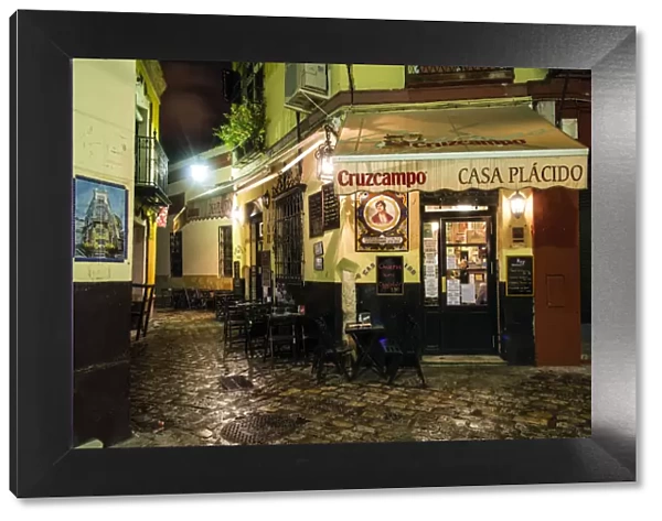 Night view of a street in barrio Santa Cruz, Seville, Andalusia, Spain