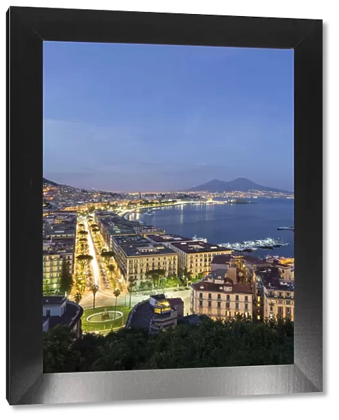 Naples, Campania, Italy. View of the bay by night and Mount Vesuvius Volcano in background