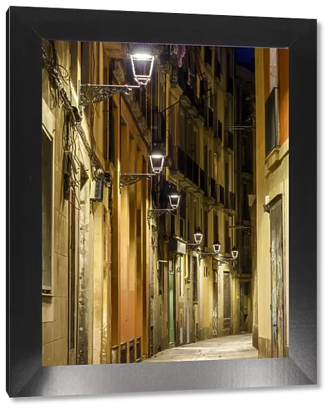 Night view of an empty street in the Gothic Quarter or Barrio Gotico, Barcelona, Catalonia