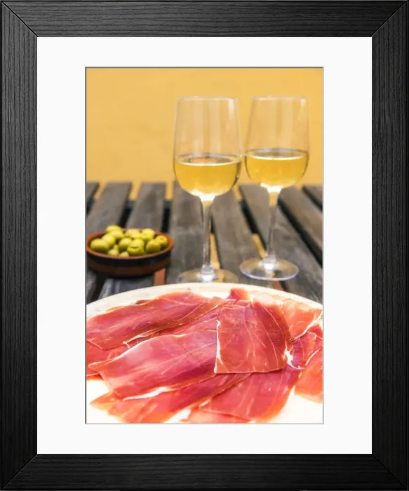 Framed Print : Spanish ham or jamon iberico served with glasses of white wine and olives in a tapas bar Framed Print : Spanish ham or jamon iberico served with glasses of white wine and olives in a tapas bar