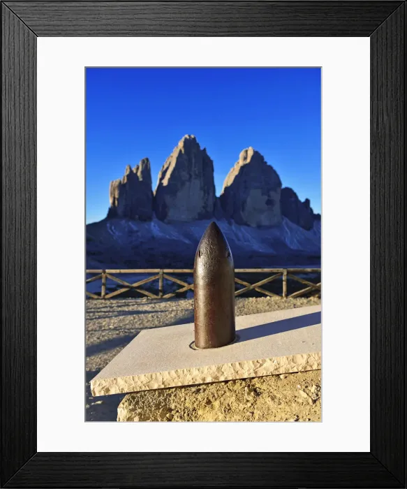 Framed Print : Grenade from the First World War before the Three Peaks Lodge, in the background Framed Print : Grenade from the First World War before the Three Peaks Lodge, in the background