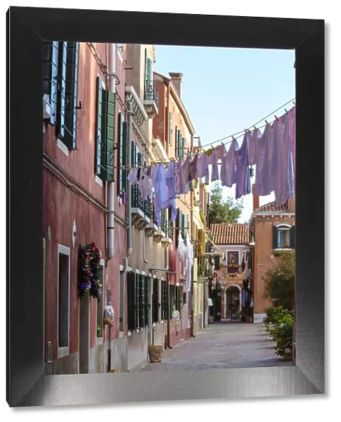 Italy, Veneto, Venice, Murano island. Typical alley with clothes hanging to dry