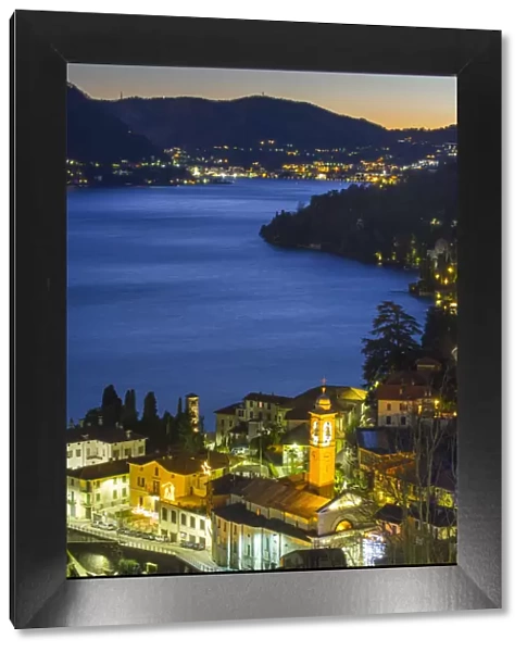 Small towns on the banks of Como lake at dusk. Como, Lombardy, Italy
