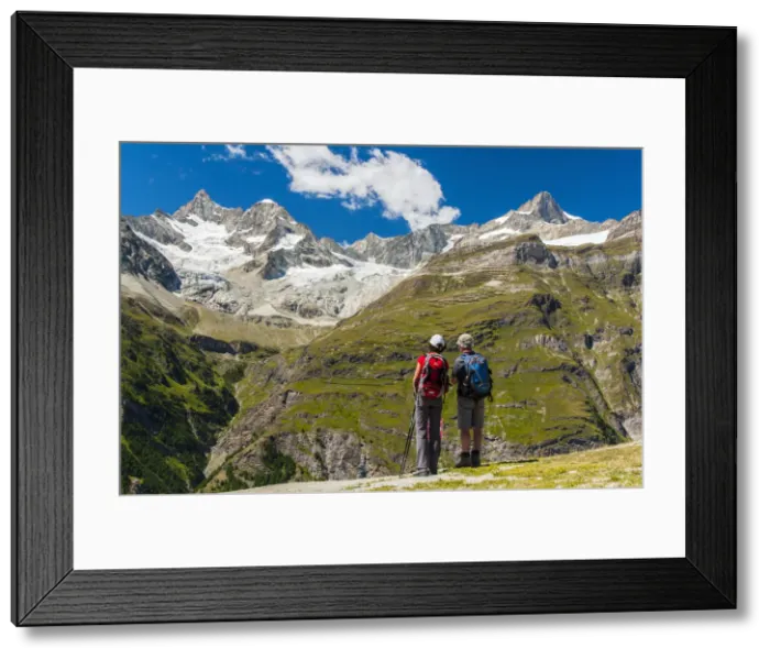 Framed Print : Two caucasian hikers watching the panorama over Swiss alps in Zermatt, Wallis, Switzerland Framed Print : Two caucasian hikers watching the panorama over Swiss alps in Zermatt, Wallis, Switzerland