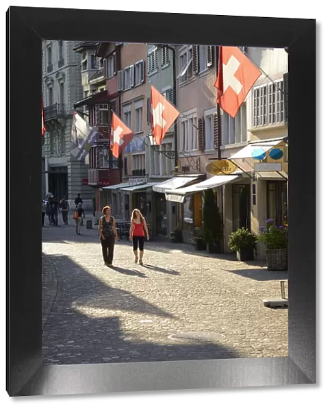 Two women walking in Augustinergasse, Zurich, Switzerland, Europe