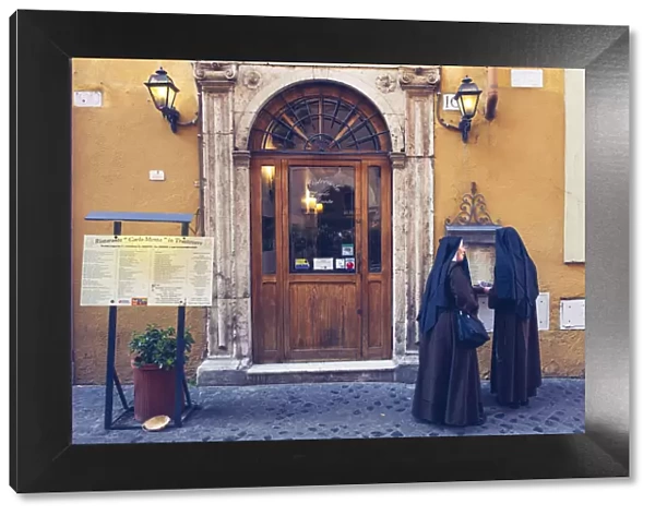 Rome, Lazio, Italy. Sisters in front of a restaurant in Trastevere