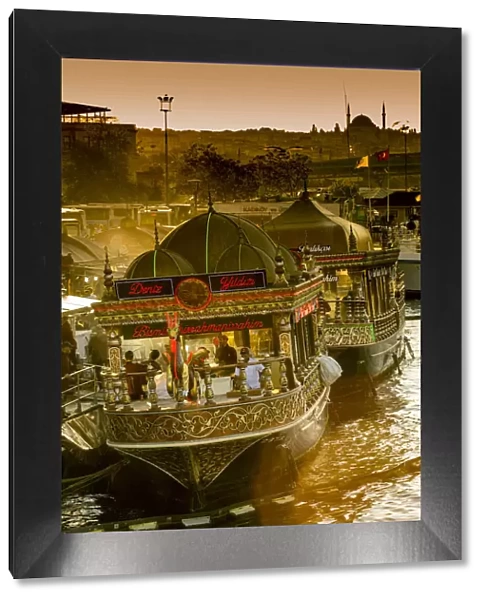 Floating restaurants boats near Galata Bridge at sunset, Istanbul, Turkey