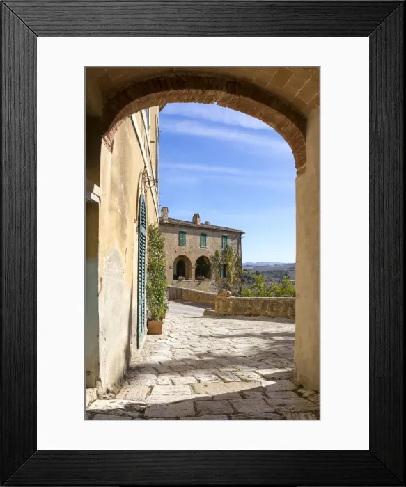 Framed Print : A stone house framed by an arch in the village of Lucignano d Asso, Val Framed Print : A stone house framed by an arch in the village of Lucignano d Asso, Val