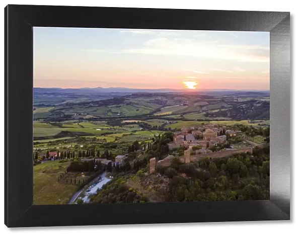 Aerial sunset over medieval town, Monticchiello, Val d Orcia, Tuscany, Italy