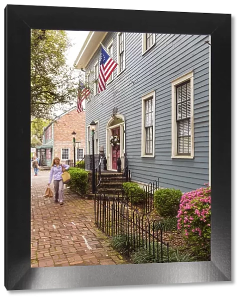 USA, Georgia, Savannah Woman walking past a typical house