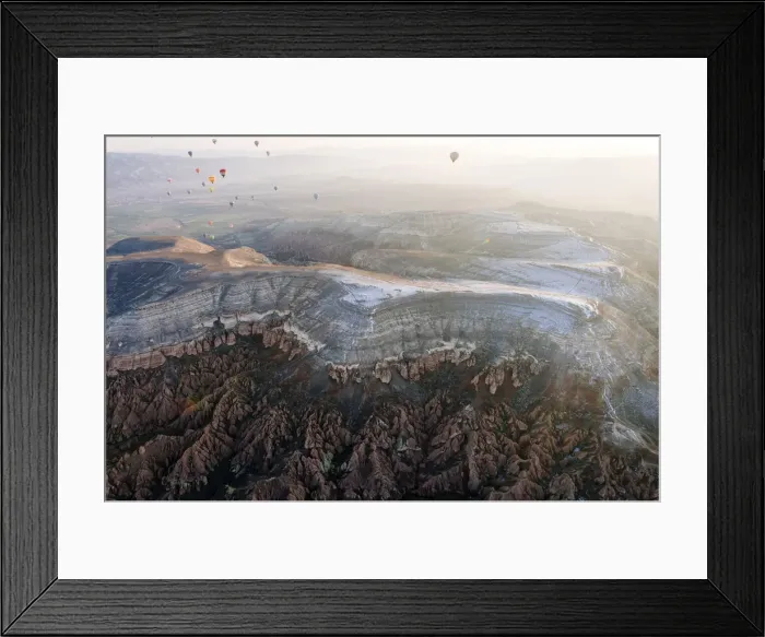 Framed Print : Overflight of Cappadocia with multicolored balloons at sunrise, snowy landscape. Turkey Framed Print : Overflight of Cappadocia with multicolored balloons at sunrise, snowy landscape. Turkey