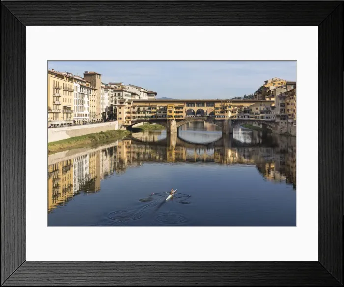 Framed Print : A woman rows on the Arno river towards the Ponte Vecchio, Florence, Tuscany, Italy Framed Print : A woman rows on the Arno river towards the Ponte Vecchio, Florence, Tuscany, Italy
