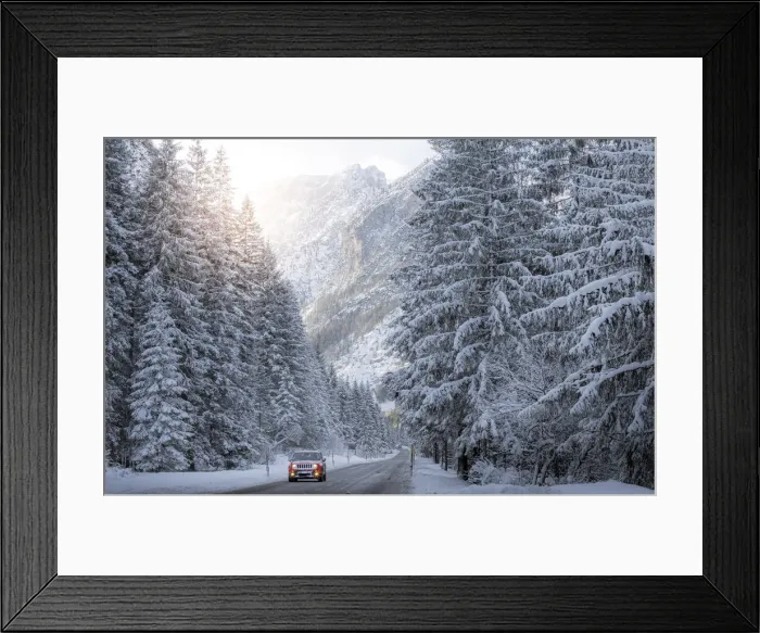 Framed Print : Scenic route with red car and snowy winter landscape, Dolomites Alps, Italy Framed Print : Scenic route with red car and snowy winter landscape, Dolomites Alps, Italy