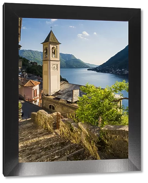 Careno, lake Como, Como province, Lombardy, Italy. The towns bell tower and the lake