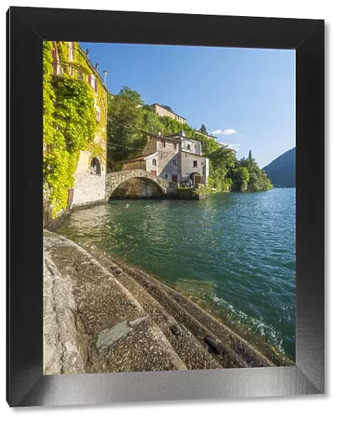 Nesso, lake Como, Como province, Italy. Lake shore and the roman stone bridge