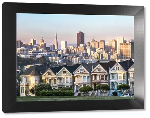 Painted ladies and skyline at sunset, San Francisco, California, USA